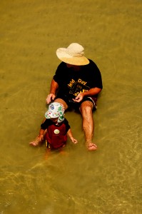 natural pappa and son in the water