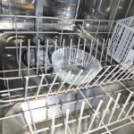 bowl of white vinegar and essential oils to clean a dishwasher naturally